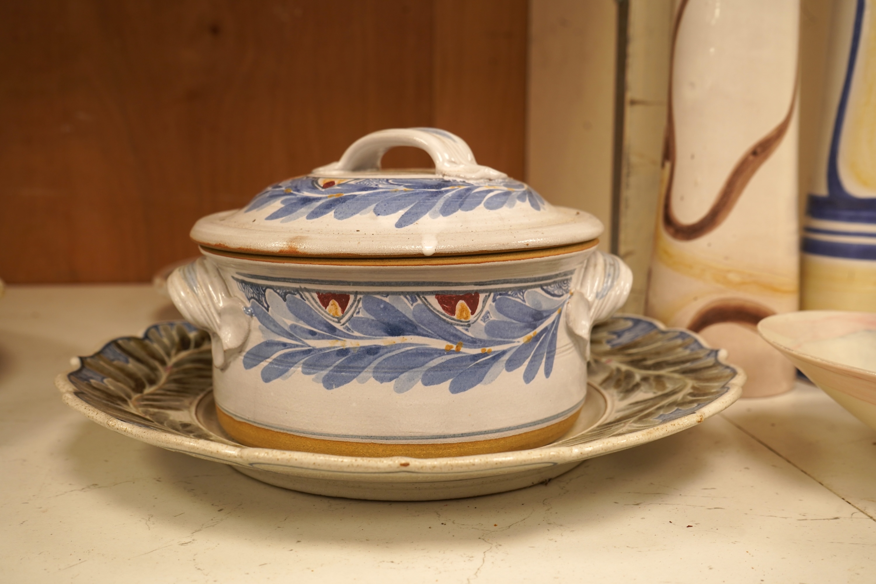 A mixed collection of European studio pottery to include a collection of four tall Italian candlesticks, tallest 58cm, two stoneware plates and a tureen and cover, etc.